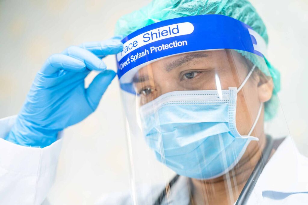 doctor in PPE faceshield, mask, surgical cap, nitrile gloves, 155615677