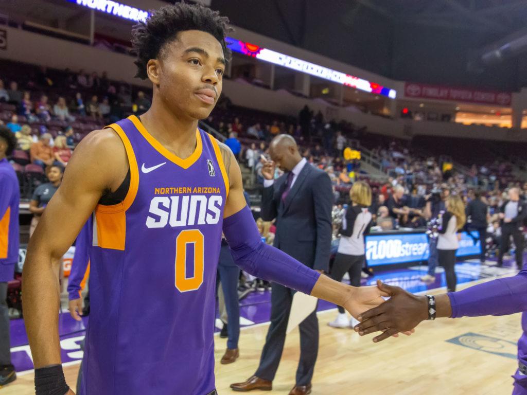 National Basketball Association player Jalen Lecque of the Phoenix Suns gives a teammate a high five on the court