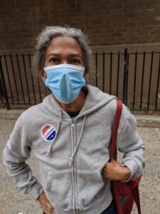 Early voter wearing mask showing need for voter and poll workers PPE