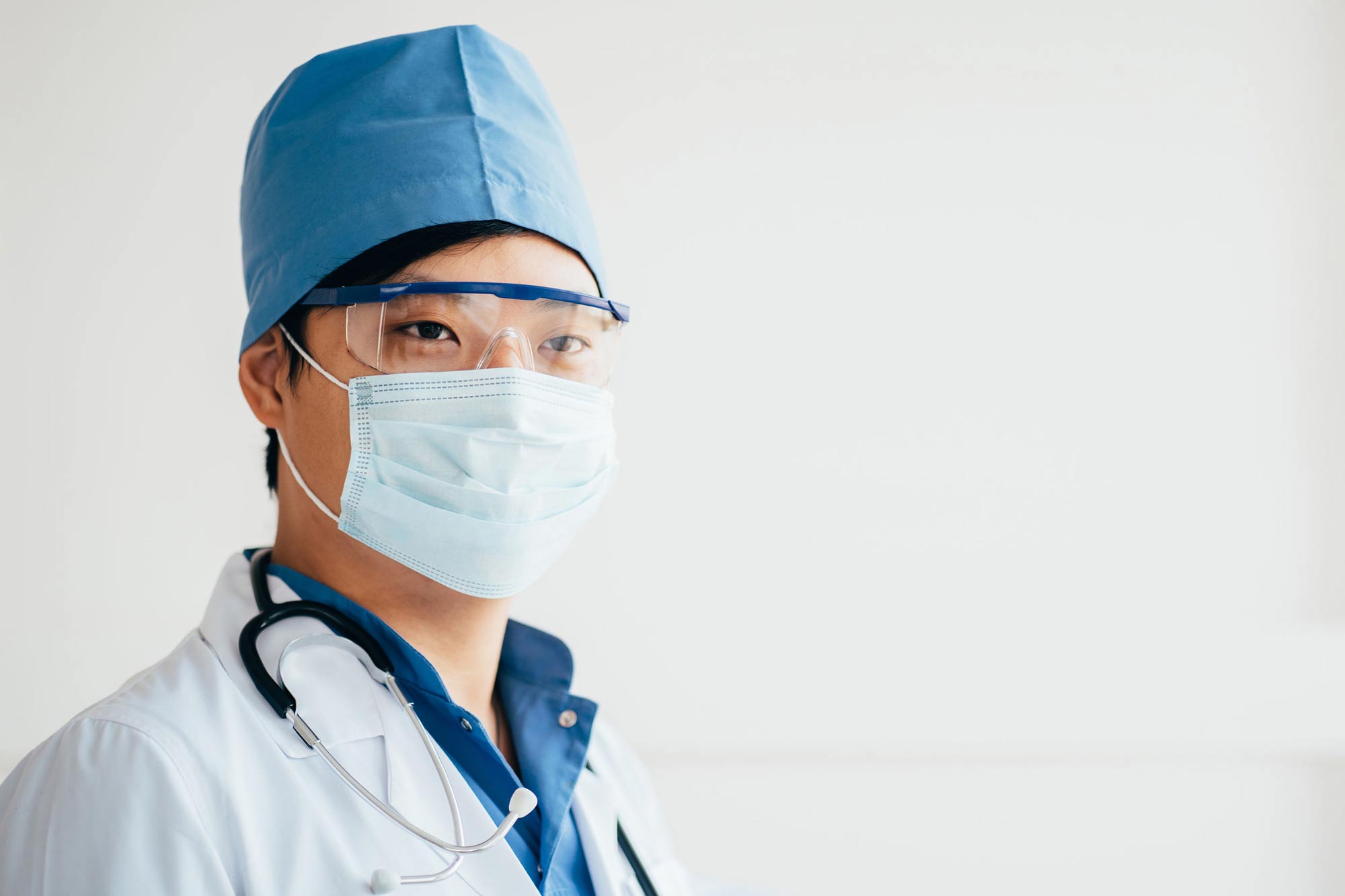 Doctor wearing PPE surgical mask and uniform