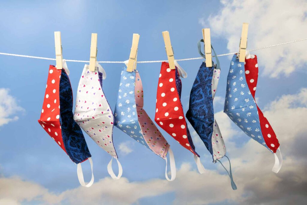 cloth face masks drying on a clothesline
