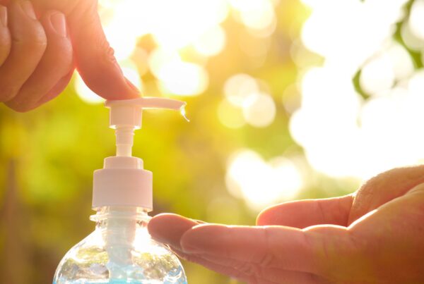 A person applying hand sanitizer